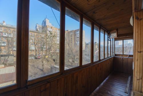 an empty room with windows looking out at a city at Partner Guest House in Kyiv