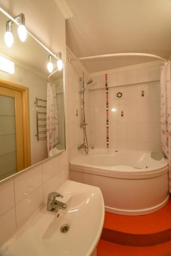 a bathroom with a sink and a bath tub at Partner Guest House in Kyiv