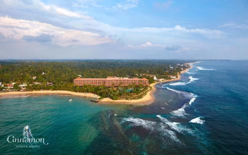 an aerial view of a resort and the ocean at Hikka Tranz by Cinnamon in Hikkaduwa