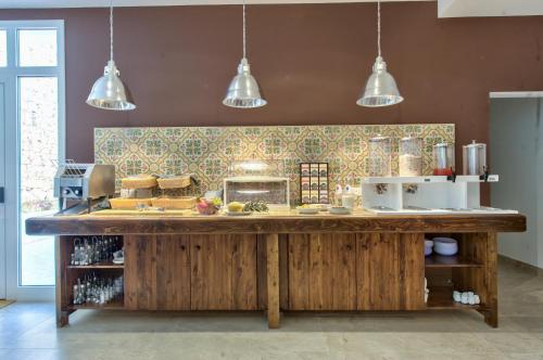 a kitchen with a large wooden counter in a room at Palazzo Violetta in Sliema