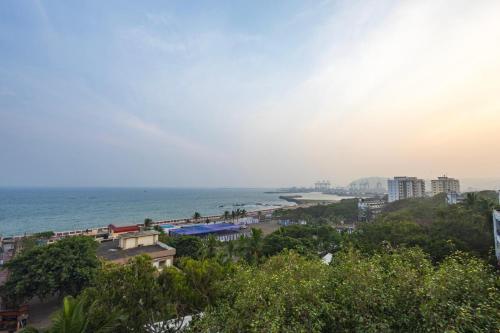 a view of a beach with buildings and the ocean at Harbourview Visakhapatnam RK Beach in Visakhapatnam