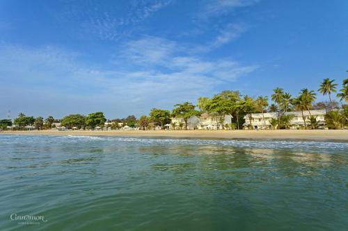 a view of a beach with houses and palm trees at Trinco Blu by Cinnamon in Trincomalee