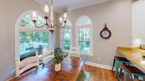 a dining room with a table and a clock on the wall at 2196 Major Loring Way SW Marietta in Macland