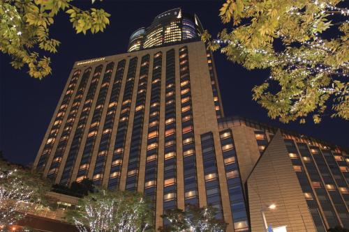 a tall building with a lot of windows at night at Grand Hyatt Tokyo in Tokyo