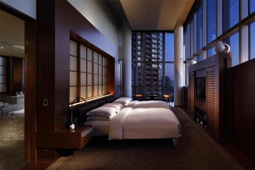a row of beds in a room with windows at Grand Hyatt Tokyo in Tokyo