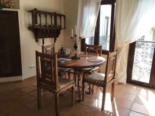 a dining room with a wooden table and chairs at Darcilla Guest House in Tarifa