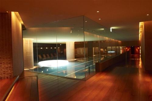 a glass room with a pool in the middle of a building at Grand Hyatt Tokyo in Tokyo