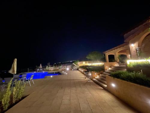 a patio at a resort at night with lights at مزرعة صوفيا السلط in Al Salt