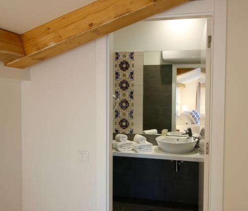 a bathroom with a sink and a mirror at Hotel Riverside Alfama in Lisbon