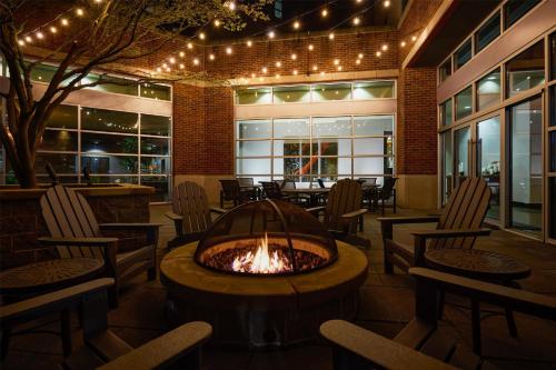a fire pit in a restaurant with chairs and tables at Hyatt House Seattle/Redmond in Redmond