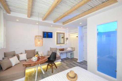 a living room with a couch and a table at Naxos Island Escape Suites in Plaka
