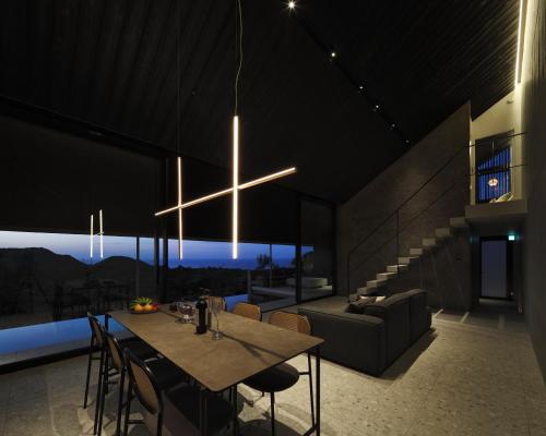 a dining room with a table and a cross hanging from the ceiling at AO NAKIJIN amahaji terrace in Nakijin