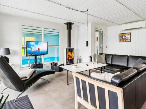 a living room with a couch and a table at 5 star holiday home in Nordborg in Nordborg