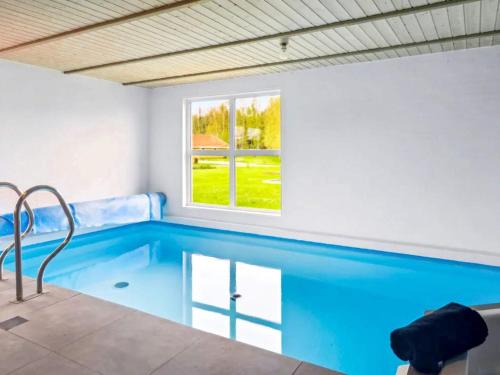 a swimming pool in a room with a window at 5 star holiday home in Nordborg in Nordborg