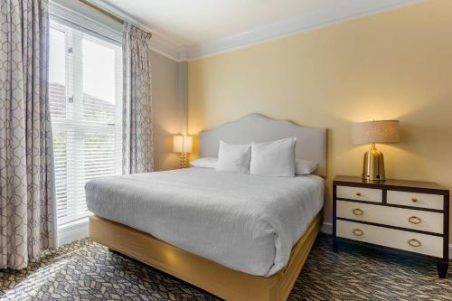 a bedroom with a bed and a window at Church Street Inn Historic Charleston, Ascend Collection Hotel in Charleston
