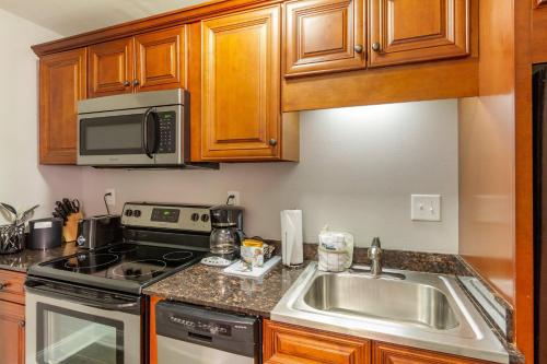 a kitchen with a sink and a microwave at Church Street Inn Historic Charleston, Ascend Collection Hotel in Charleston