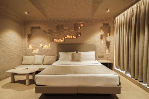 a bedroom with a bed and a table and some lights at Dragonfly Hotel - The Art Hotel in Mumbai