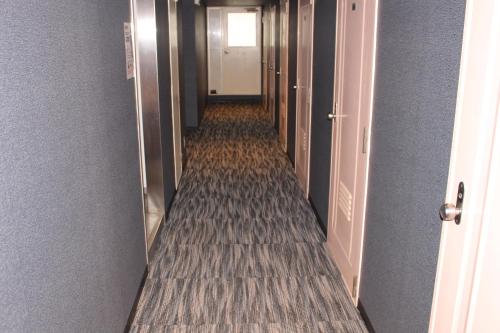 a hallway of an office building with a long corridor at Hotel Sunplaza 2 in Osaka