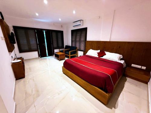 a bedroom with a large bed with a red blanket at Serenity View in Batheri