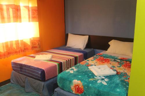 Ein Bett oder Betten in einem Zimmer der Unterkunft Rc Guest House