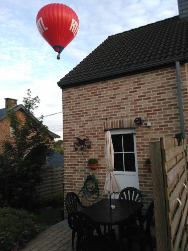 a hot air balloon flying over a house at Vakantiestudio Ciney in Chapois