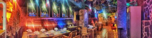 a view of a restaurant with tables and chairs at Deep Forest Garden Hotel in Puerto Princesa City