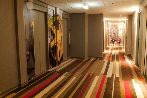 a hallway with a striped floor in a building at ibis Paris La Defense Courbevoie in Courbevoie