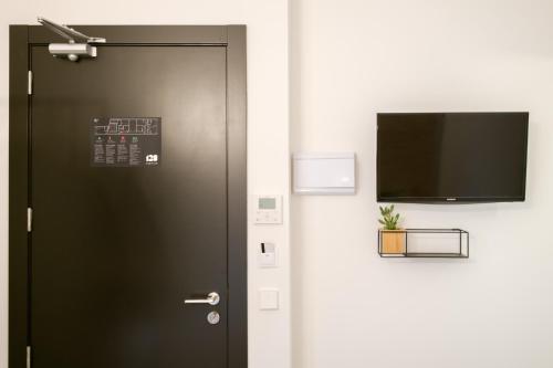 a black door with a flat screen tv on it at Magatzem 128 in Barcelona