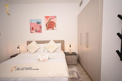 a bedroom with a white bed with white sheets at 1BR Stylish Apartment - Rossa Urban Yas Island in Abu Dhabi