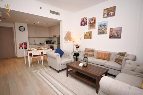 a living room with a couch and a table at 1BR Stylish Apartment - Rossa Urban Yas Island in Abu Dhabi
