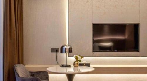 a living room with a table and a tv at Taiyi International Hotel in Wenzhou