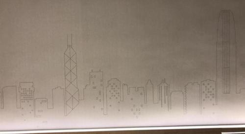 a drawing of a city skyline on a wall at West Hotel in Hong Kong