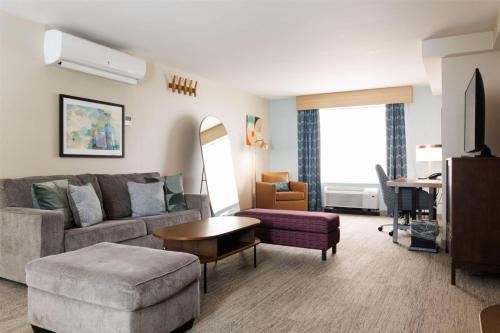 a living room with a couch and a table at Hilton Garden Inn New York/Staten Island in Staten Island