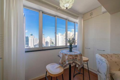 a room with a table and a view of the city at Book and Bed-People's Square in Shanghai