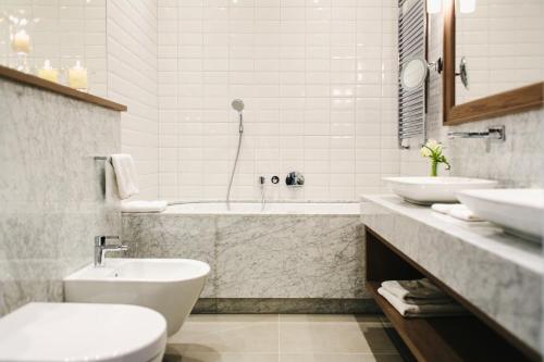a bathroom with a sink, toilet and bathtub at Art Hotel in Wrocław