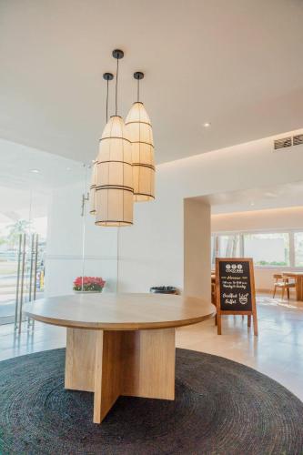 a dining room with a table and a chandelier at Comfort Inn Puerto Vallarta Golfside & Marina in Puerto Vallarta