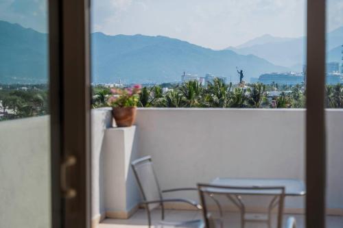 a view of a balcony with chairs and a table at Comfort Inn Puerto Vallarta Golfside & Marina in Puerto Vallarta