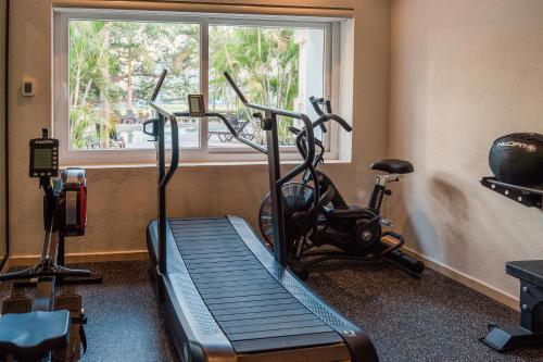 a gym with two exercise bikes and a window at Comfort Inn Puerto Vallarta Golfside & Marina in Puerto Vallarta