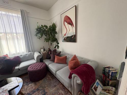 a living room with a couch and a chair at Wyreema, Heritage Cottage in Geelong West