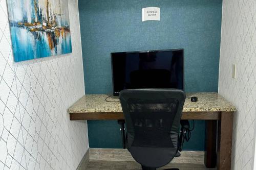 a desk with a computer and a chair in a room at Quality Inn & Suites Clemmons I-40 in Clemmons