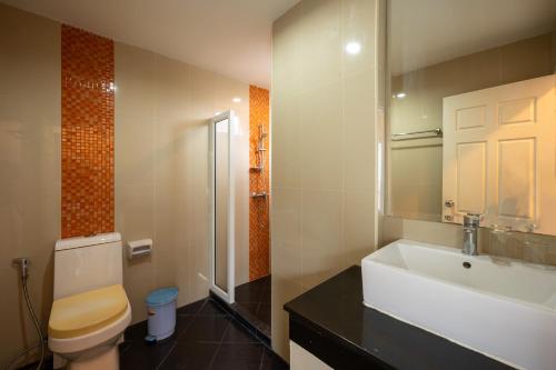 a bathroom with a toilet and a sink at New Nordic Suites 2 by Apartwell in Pattaya South