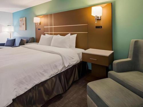 a hotel room with two beds and a chair at Best Western Galt Inn in Galt