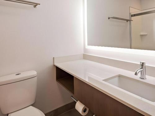 a bathroom with a sink and a toilet and a mirror at Best Western Galt Inn in Galt