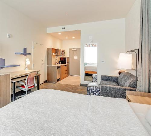 a hotel room with a bed and a desk and a couch at Home2 Suites By Hilton Crestview I-10 in Crestview