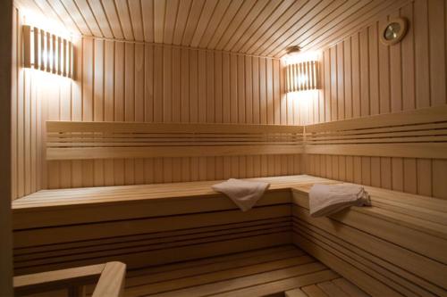 a sauna with two benches and two lights in it at BEST BALTIC Kaunas in Kaunas