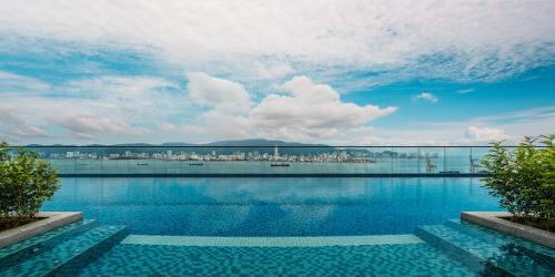 a swimming pool with a view of a city at Crowne Plaza Penang Straits City by IHG in Perai