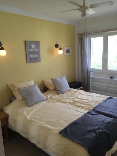 a bedroom with a large bed with two pillows at Ocean Point in Mijas Costa