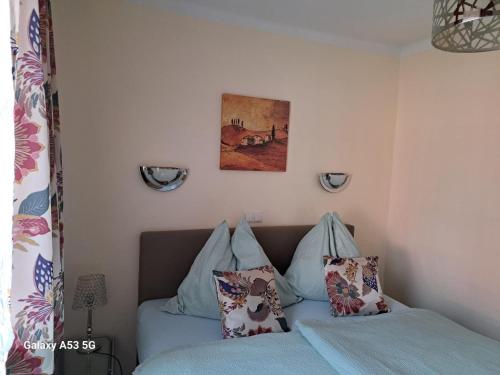 a bedroom with a bed and a picture on the wall at Apartment in Feld am See by Brennsee Lake in Feld am See