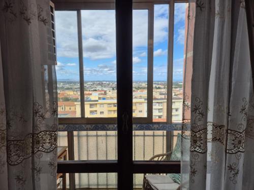 a view of a city from a window at La terrazza di Anna in Sassari