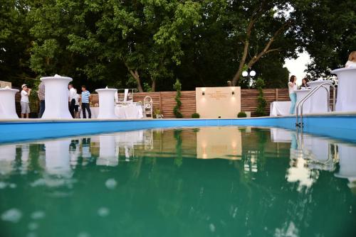 a pool of water with people standing around it at Bacolux Craiovita, Craiova in Craiova